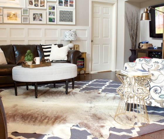 Beige brindle cowhide rug on top of a gray and white lassic rug