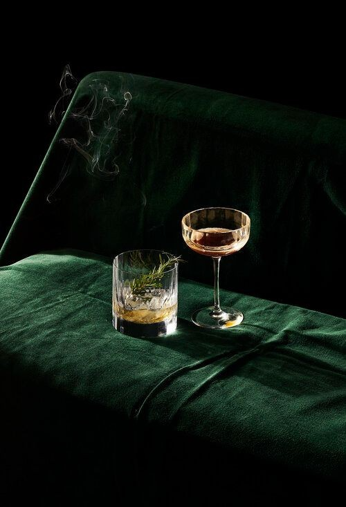 Green Velvet couch and fancy cocktail glasses