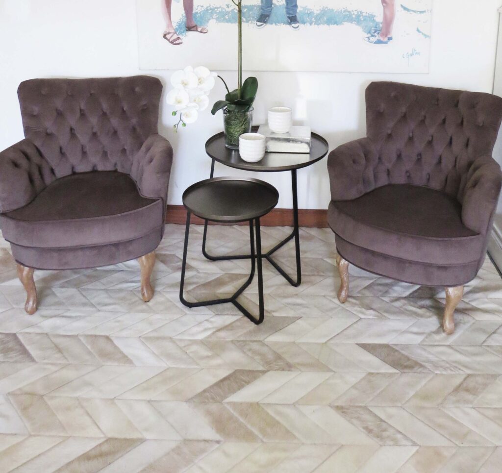 Reading nook with armchairs and a Wheat toned Chevron Patchwork Cowhide Rug by Shinne Rugs