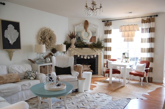 boho style living room with hide and patchwork cowhide rug layering limiting the space