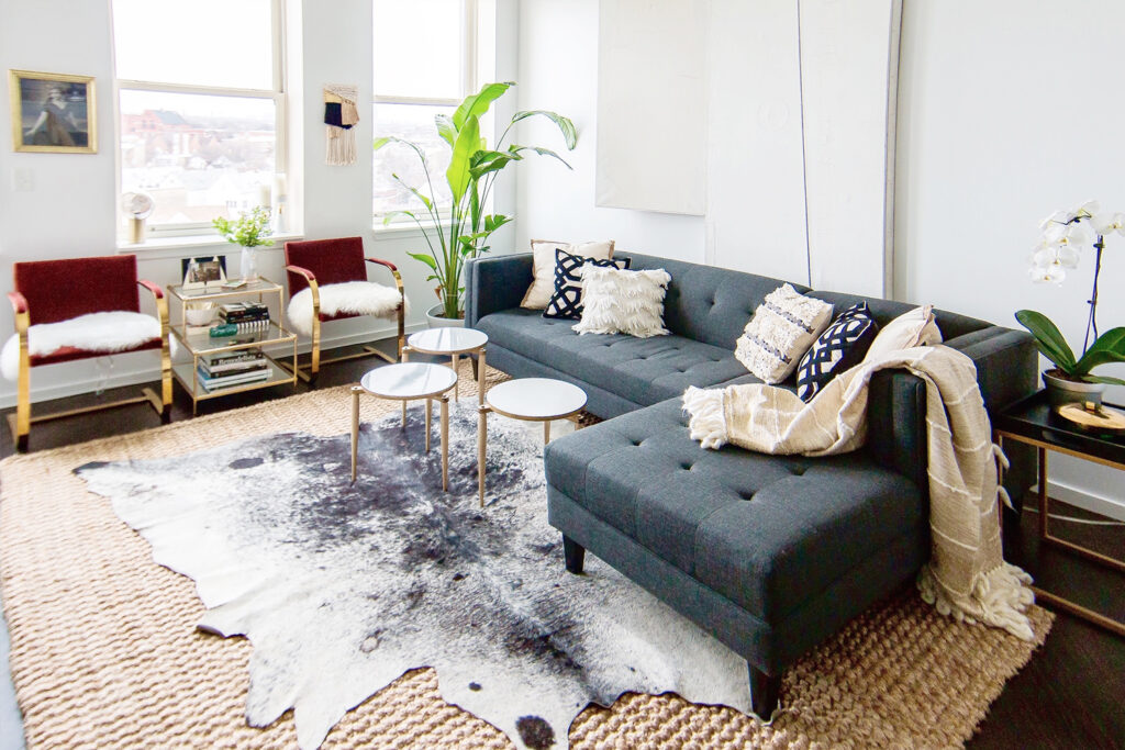 Gorgeous Brindle Cowhide combined with gray sofa and natural fiber rug