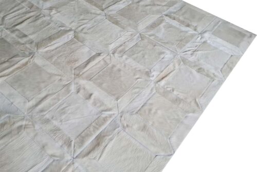 Side view of a Cube Patch Cowhide Rug in White