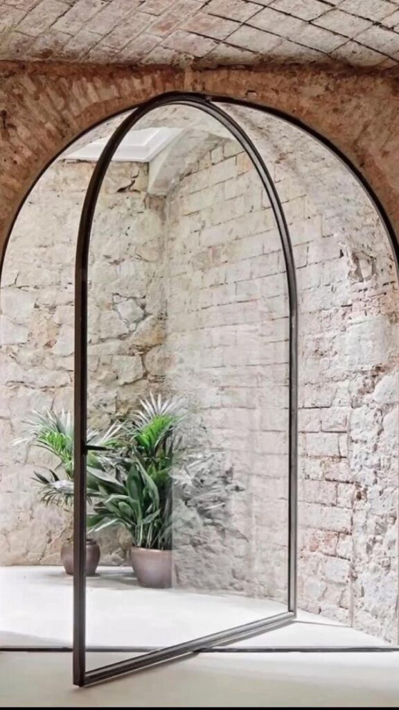 arched window with pivot system and exposed brick