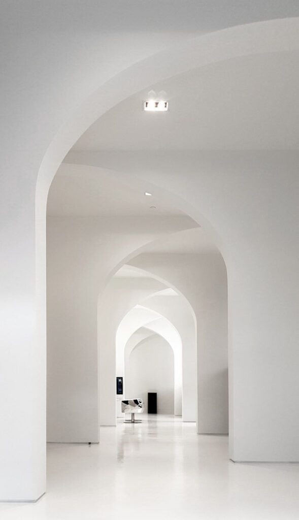 all white overlapped arches in great architectural space