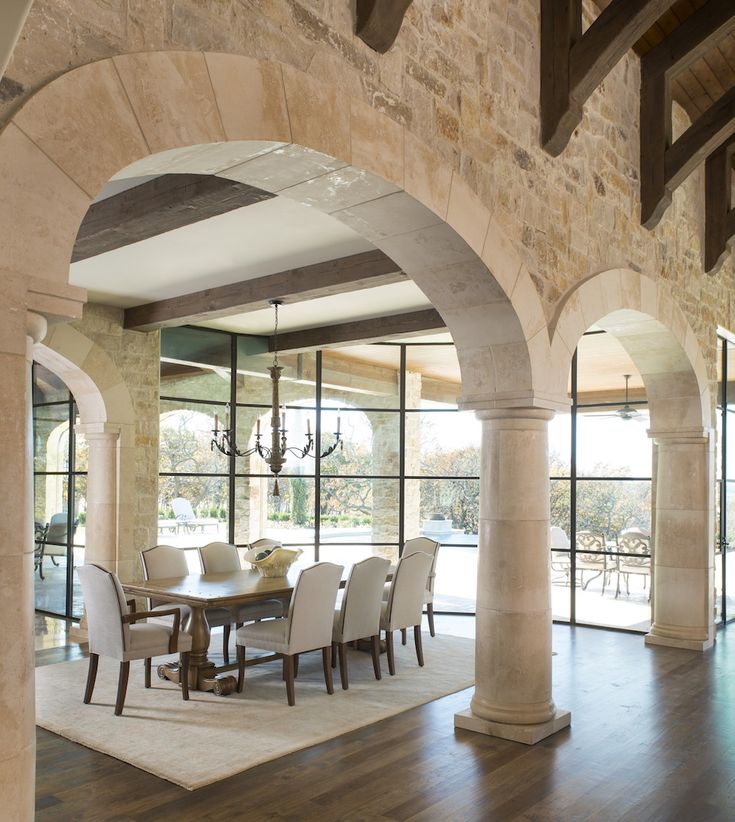 arch room dividers with columns and exposed brick in big dinning room