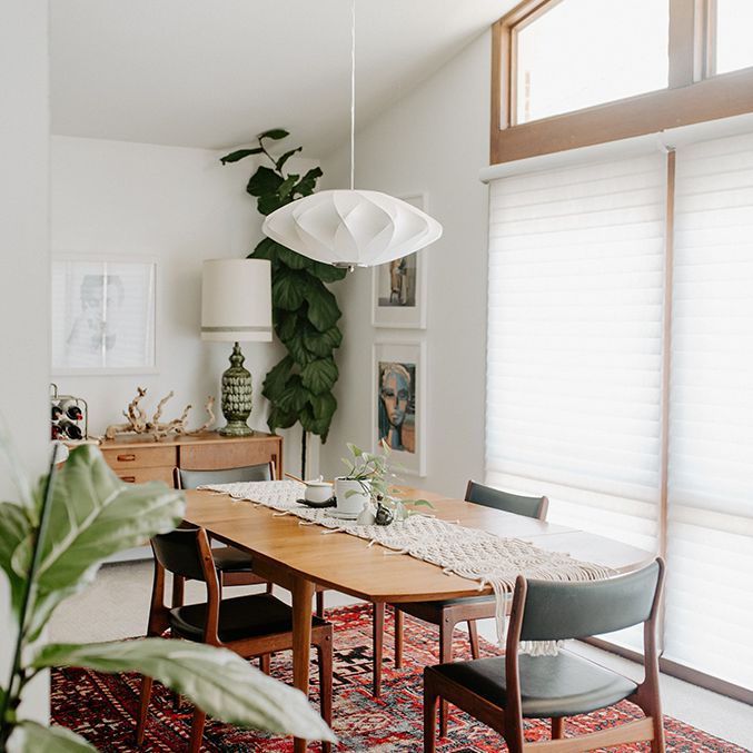 small apartment aesthetic - dining room with wooden table and red rug