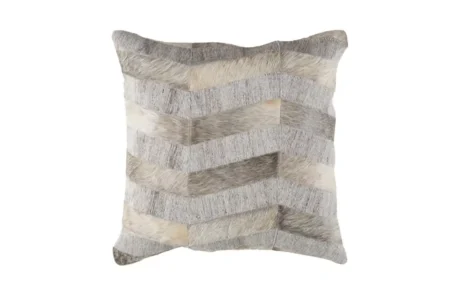 0 Mixed cowhide fabric Chevron pillow in creamy gray Chevron-patterned decorative cushion showcasing realistic textures of stitched cowhide and woven fabric in a neutral palette of gray, taupe, and cream.