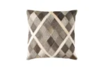 Product photograph of a square throw pillow featuring a natural hair-on-cowhide patchwork design. The cushion displays a sophisticated diagonal diamond pattern in varying shades of charcoal grey, taupe, and deep brown. The sections are defined by clean, cream-colored hide bands, creating a sharp, geometric Argyle-style grid.
