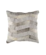 Close-up of a square decorative throw pillow featuring a textured chevron patchwork design made of alternating strips of gray, cream, and beige natural cowhide and woven fabric.