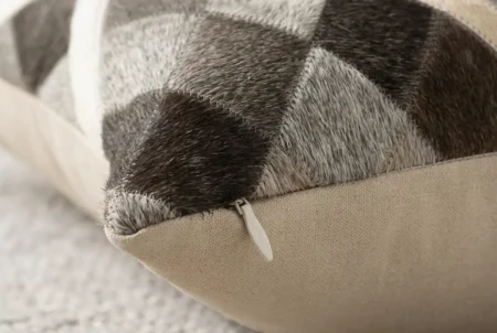 Lime taupe Cowhide pillow zipper detail Zipper detail on a Lime patchwork cowhide pillow in taupe, gray and beige tones.